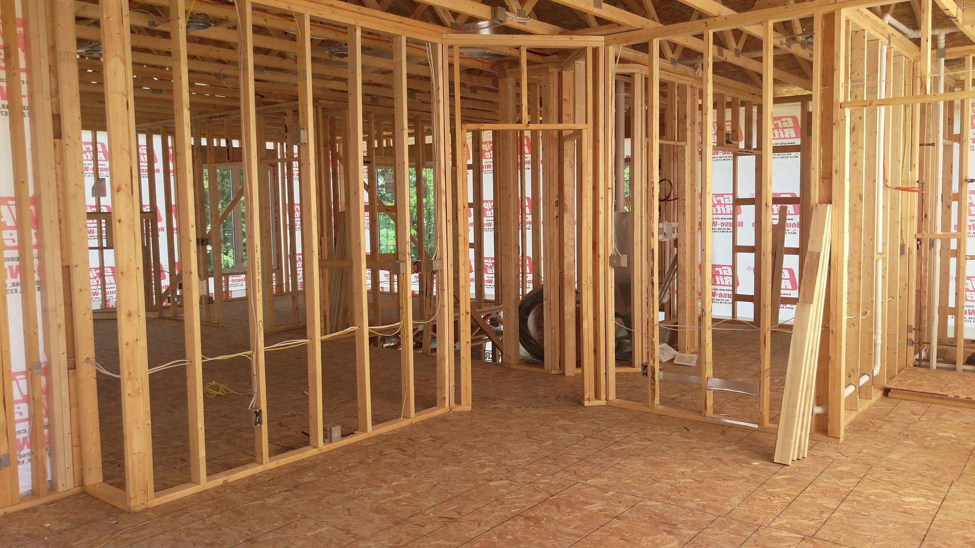 A room in a house under construction with wooden walls.