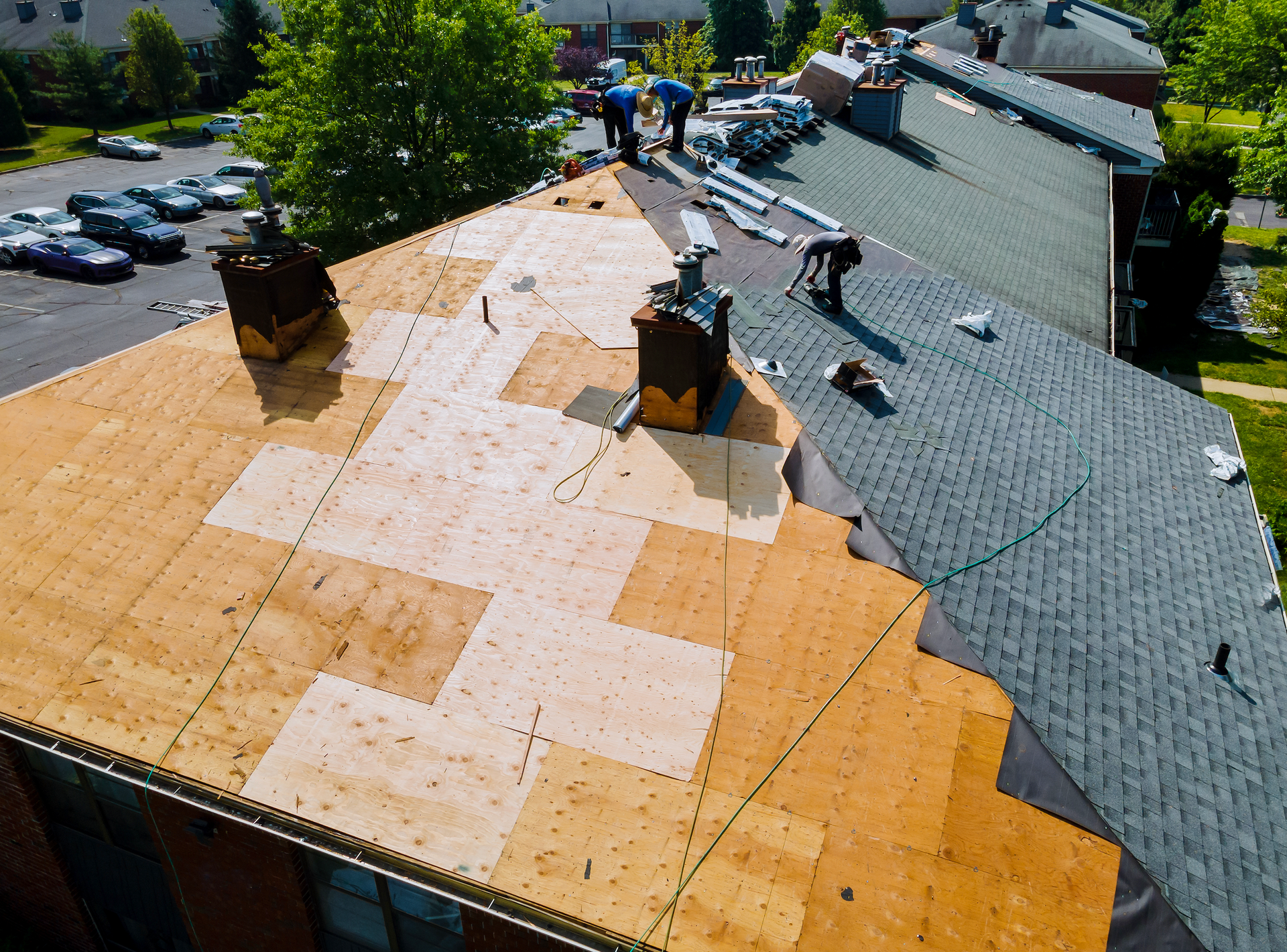 A group of people are working on the roof of a building.