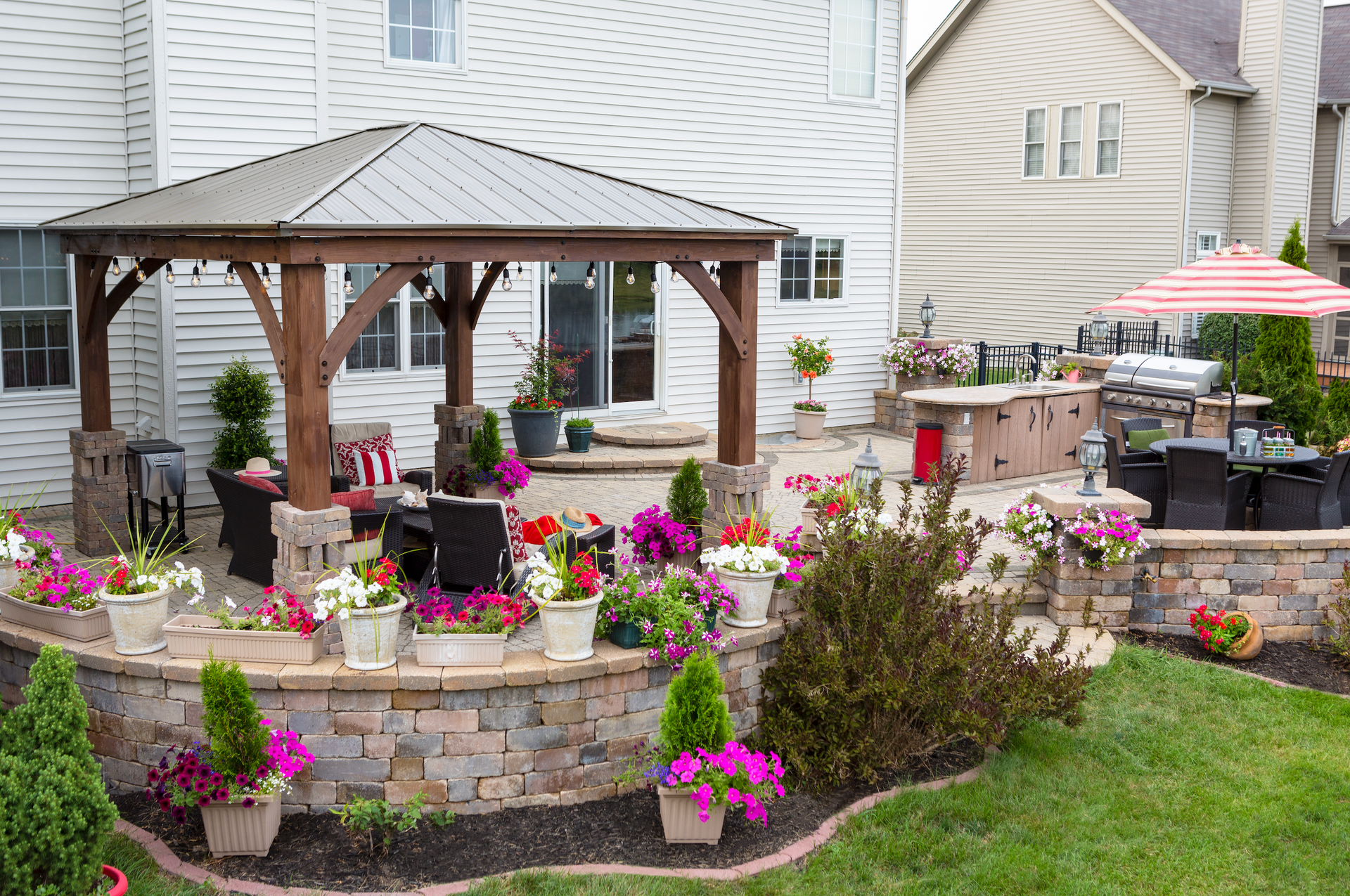 There is a gazebo in the backyard of a house.