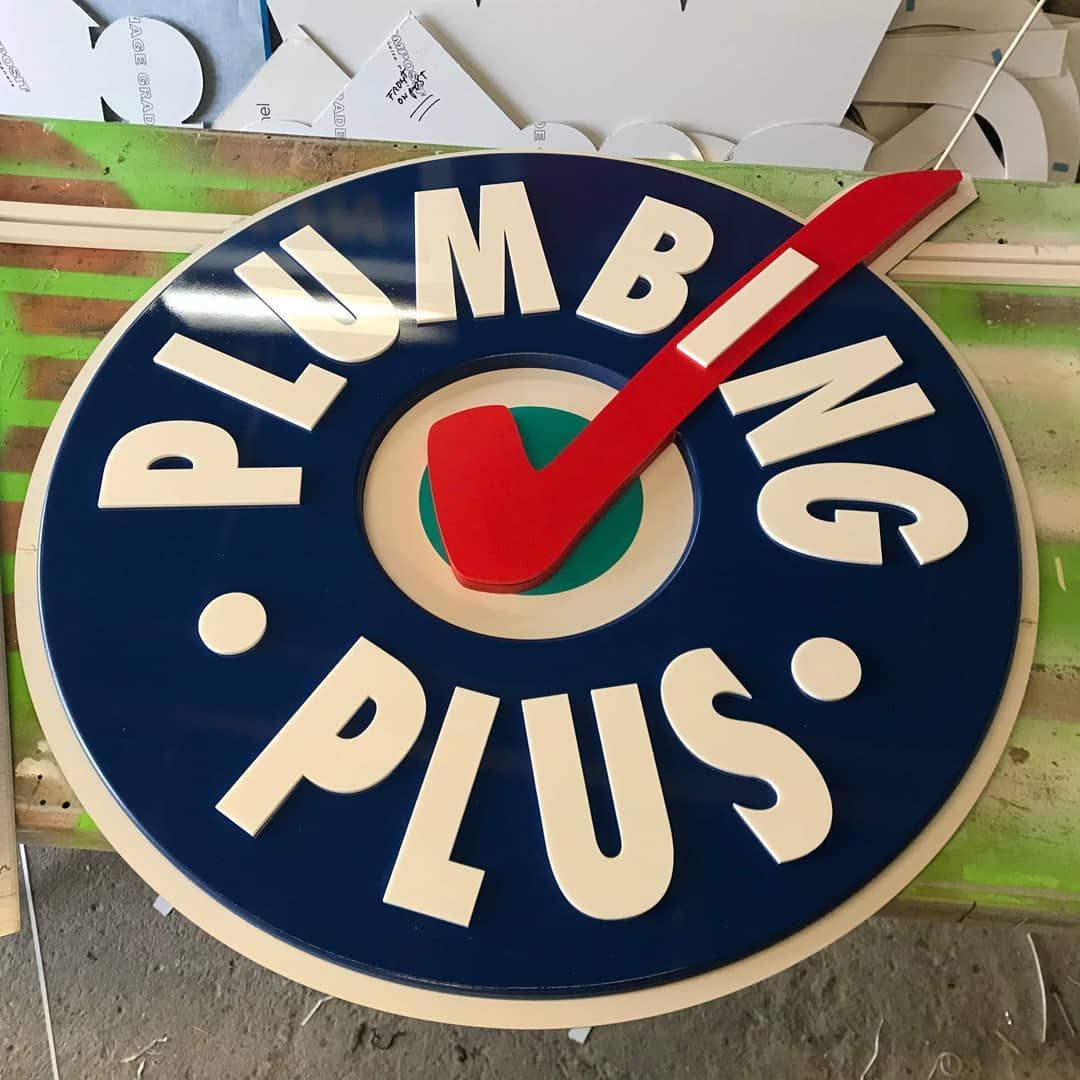 A Sign for Plumbing Plus Has a Red Check Mark in the Center — Coastal Plastics In Tweed Heads South, NSW