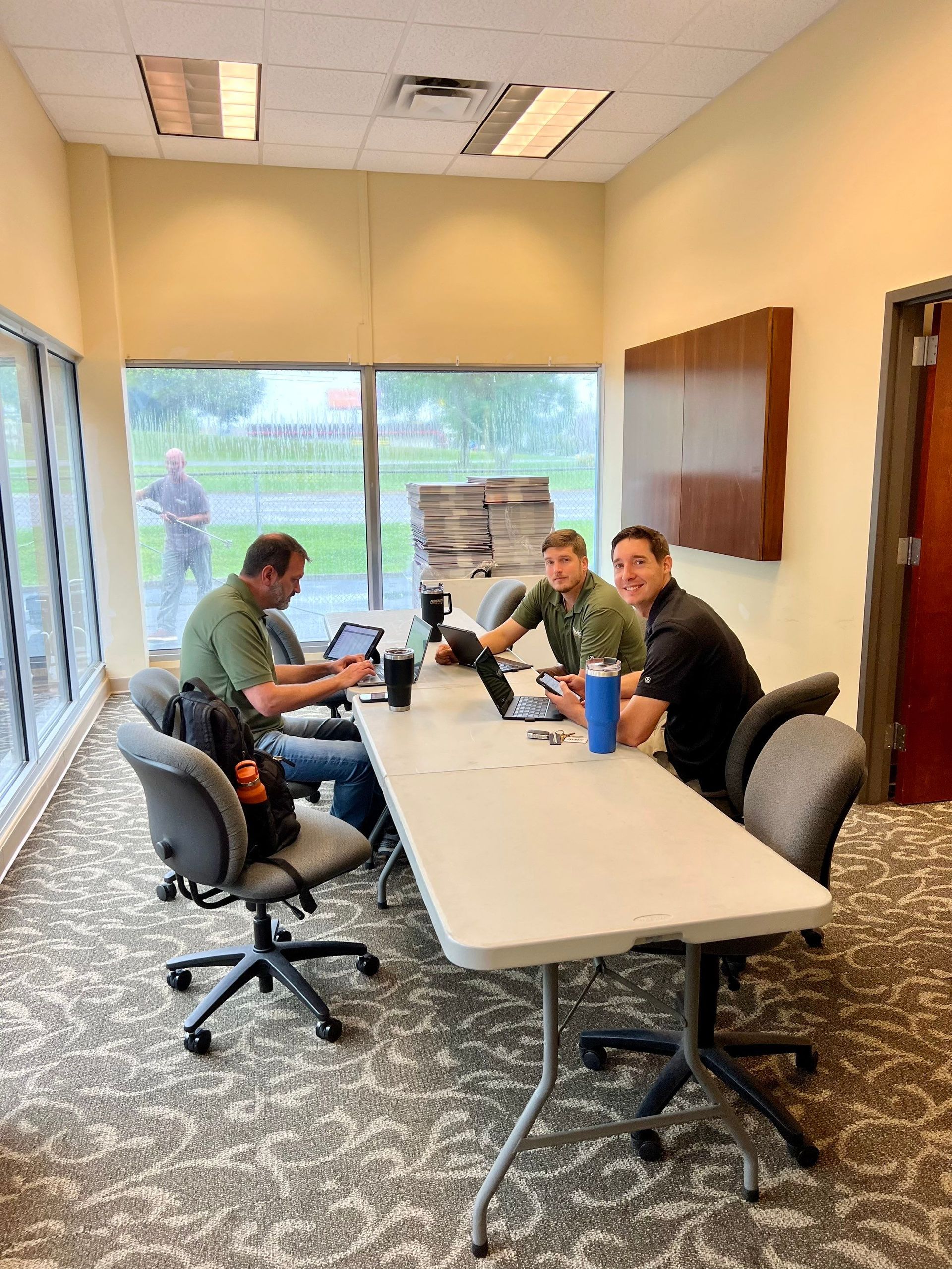 A group of men are sitting at a long table in a conference room.