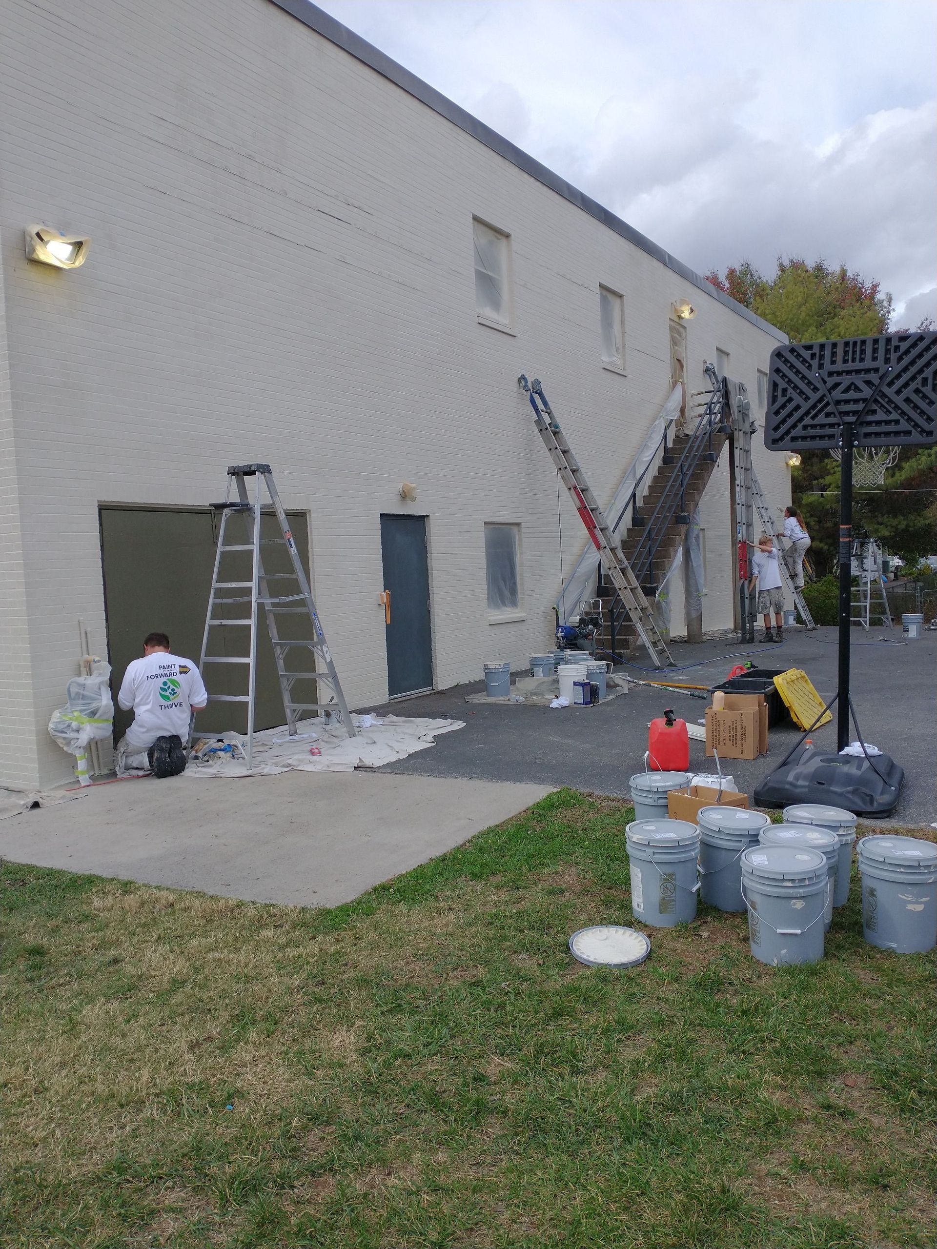 A man is painting the side of a building.