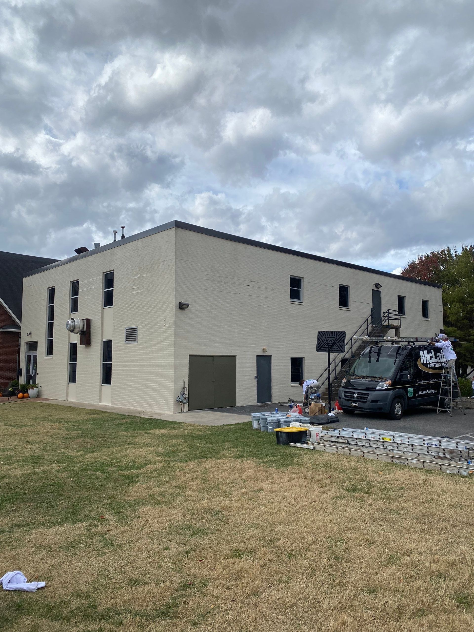 A large building with a van parked in front of it.