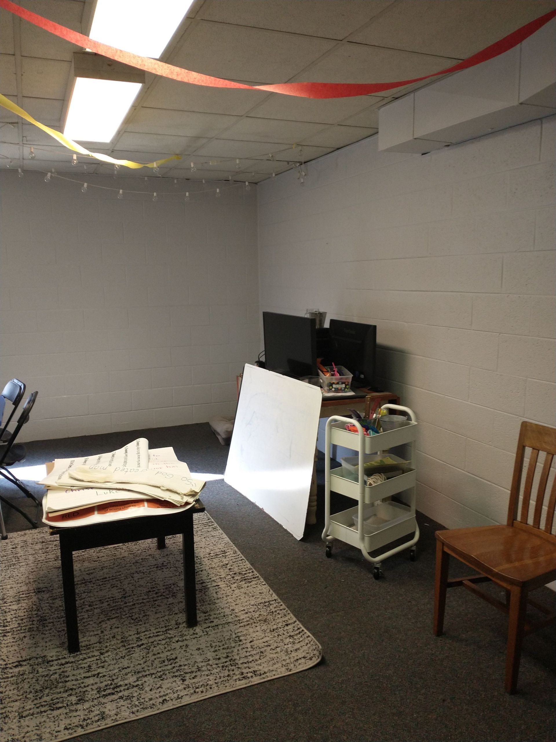 A room with a table and chairs in it