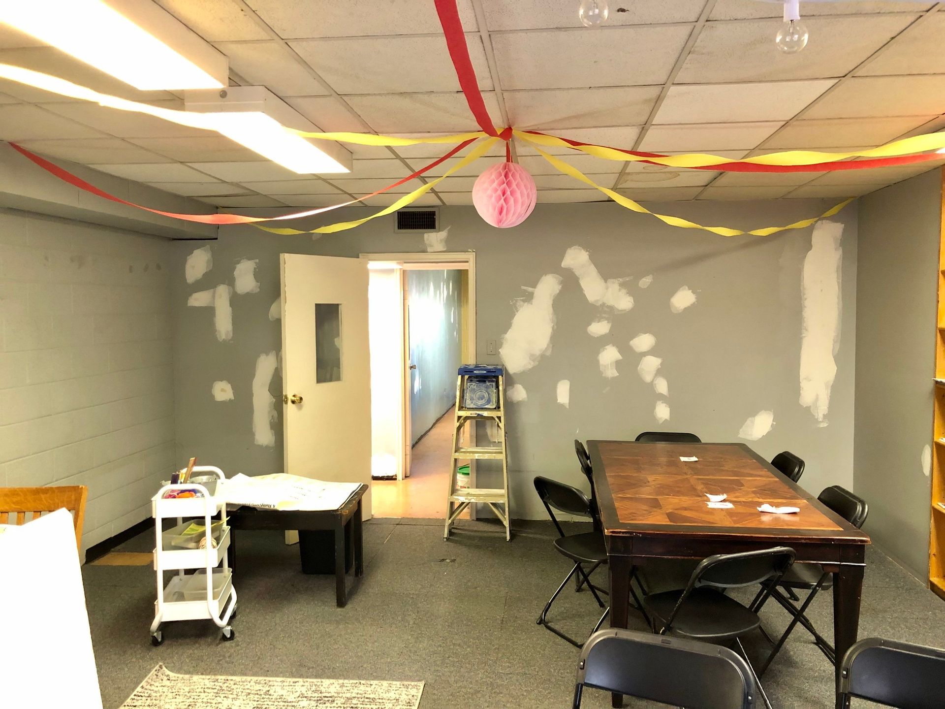 A room with a table and chairs in it