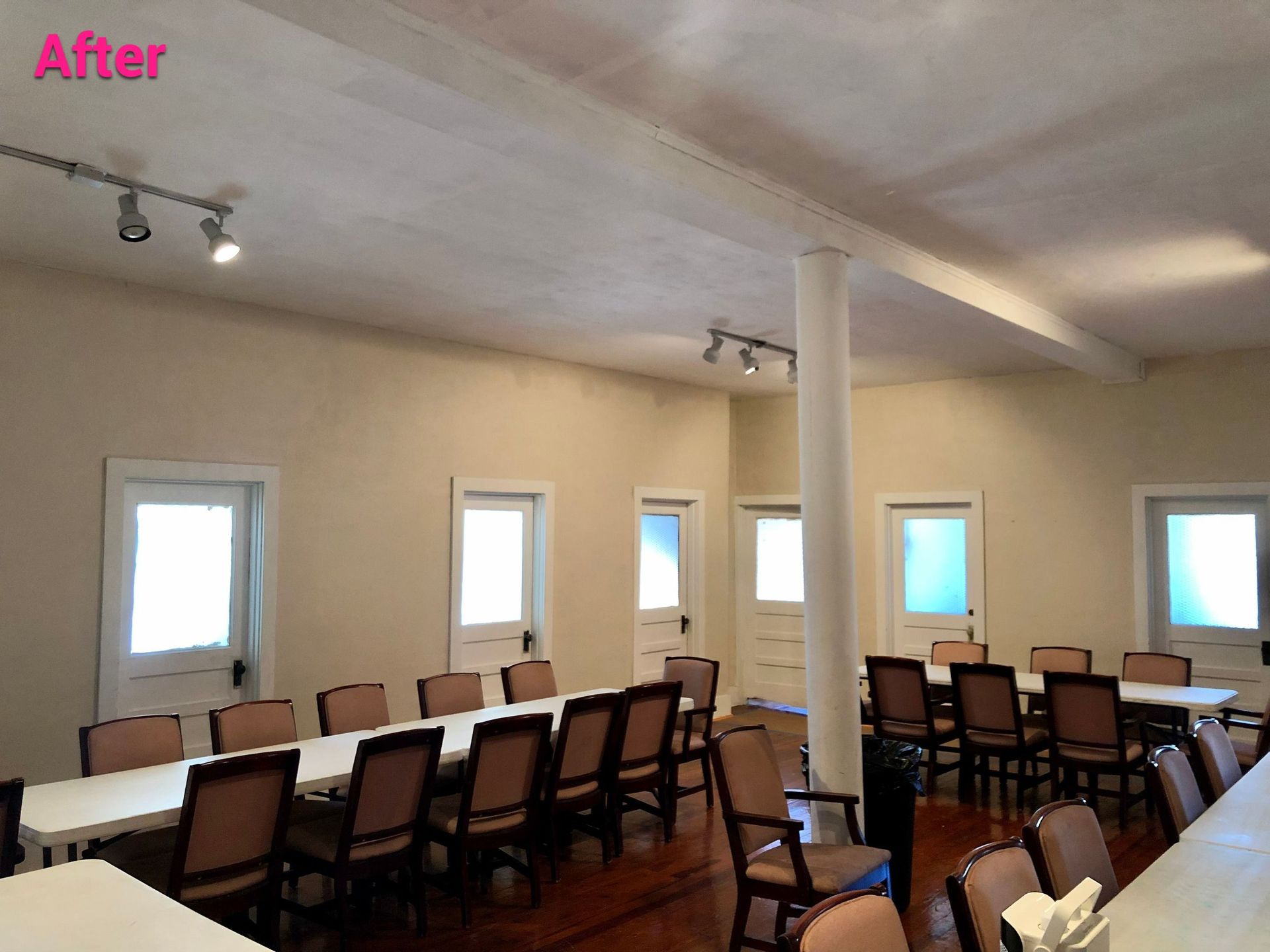 A room with tables and chairs and the words after on the bottom