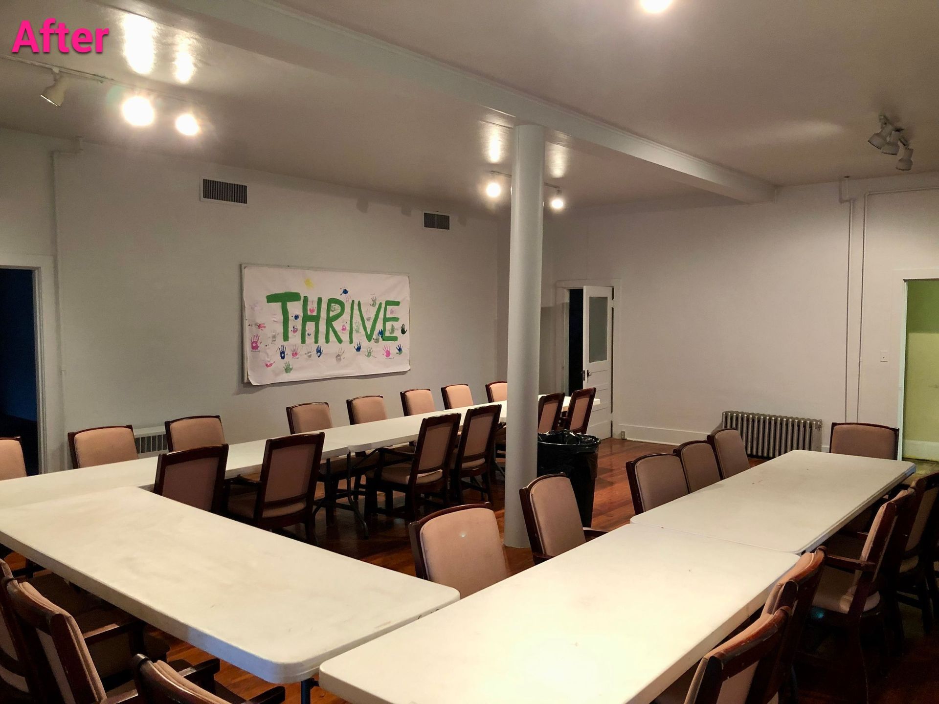 A room with tables and chairs and a sign that says thrive