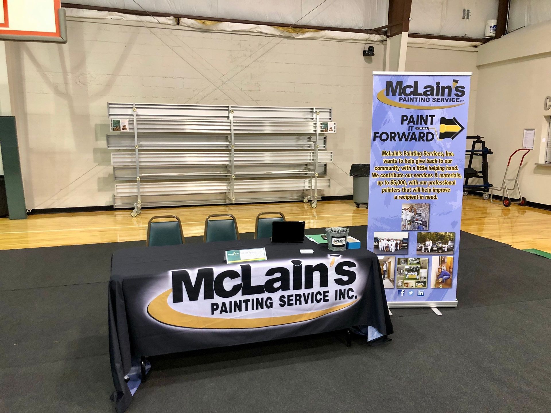 A table with a sign that says mclain 's painting service inc.
