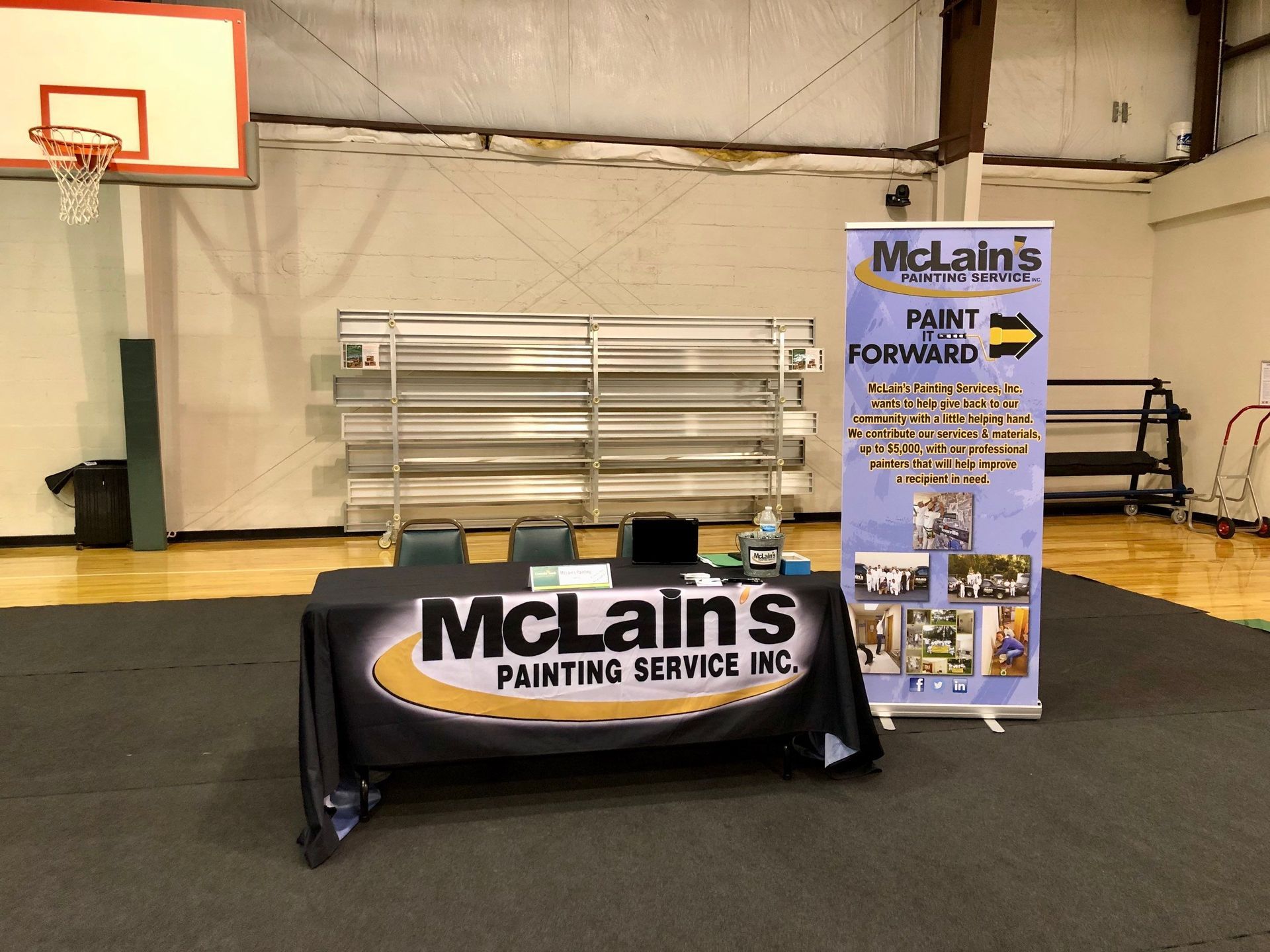 A table with a mclain 's painting service sign on it