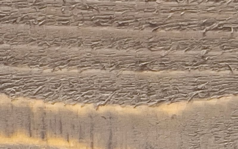 A close up of a piece of wood with a yellow stripe on it.