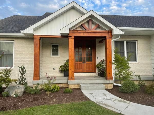 A white house with a porch and a wooden door