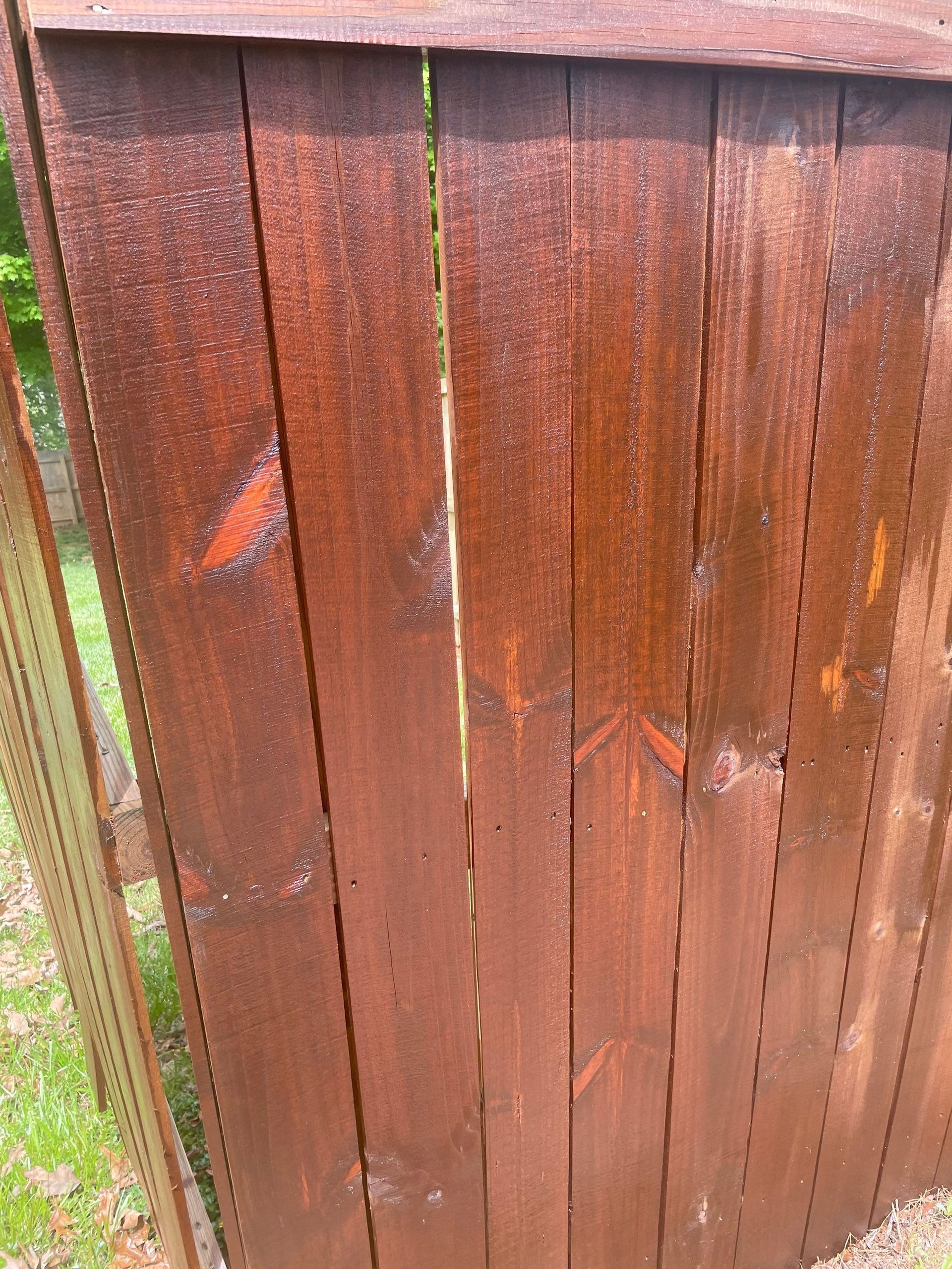 A close up of a brown wooden fence on a sunny day.