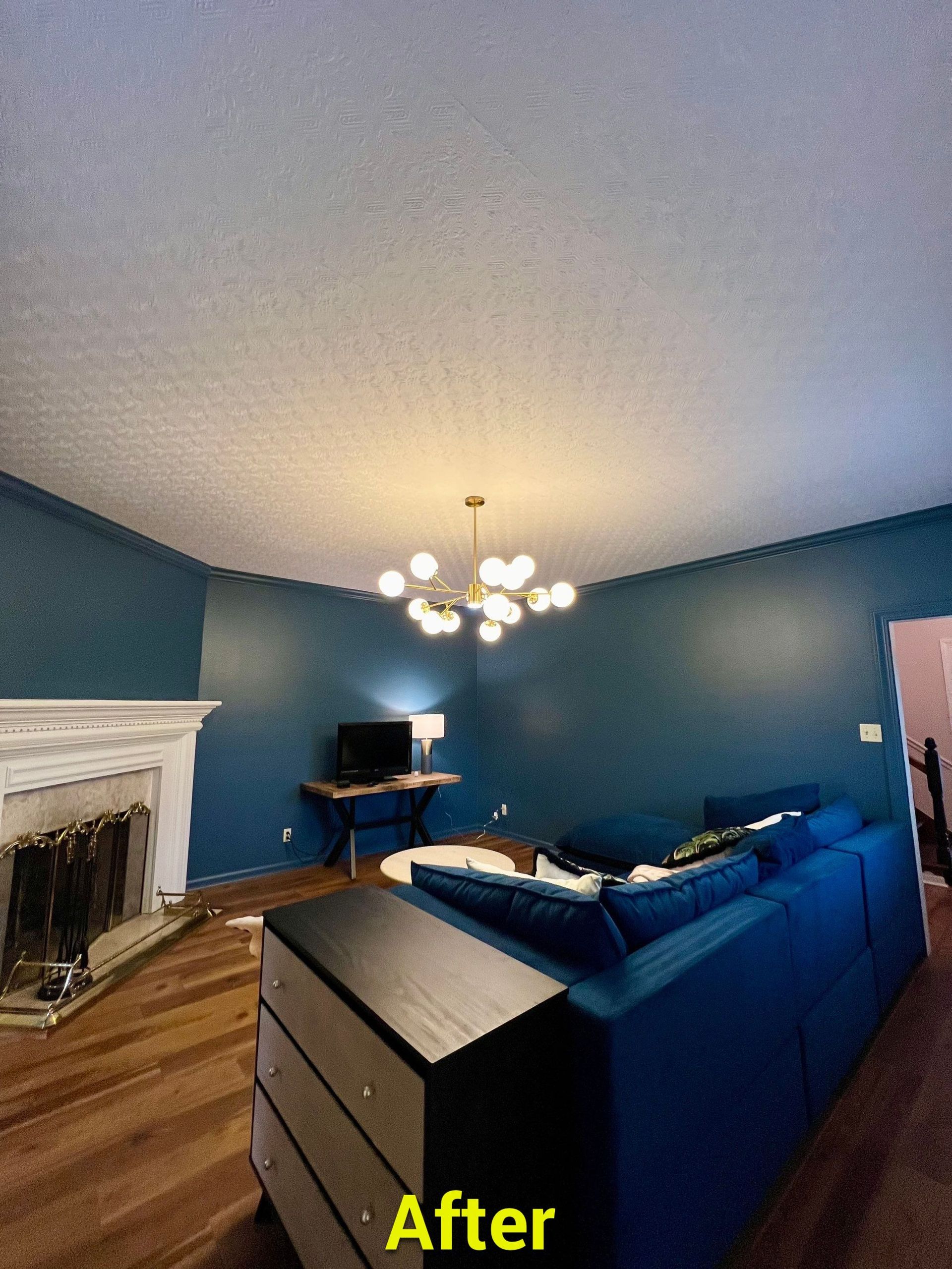 A living room with blue walls and a blue couch