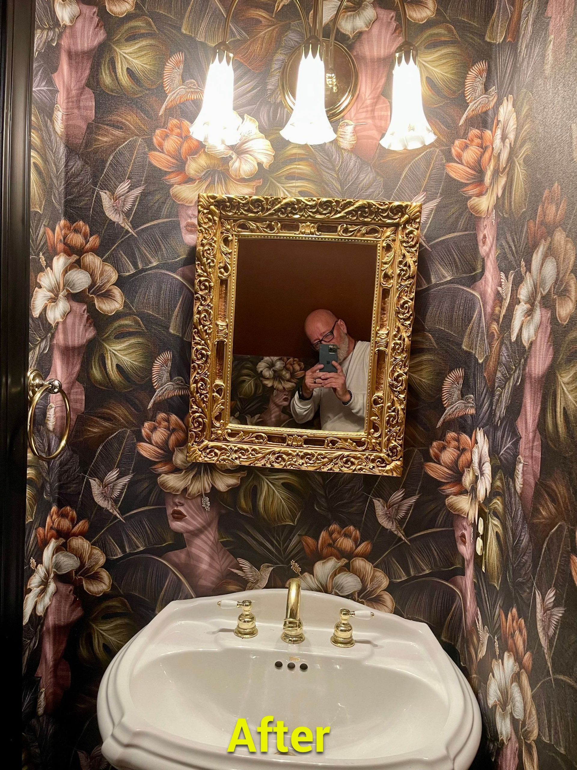 A man is taking a picture of himself in a bathroom mirror.