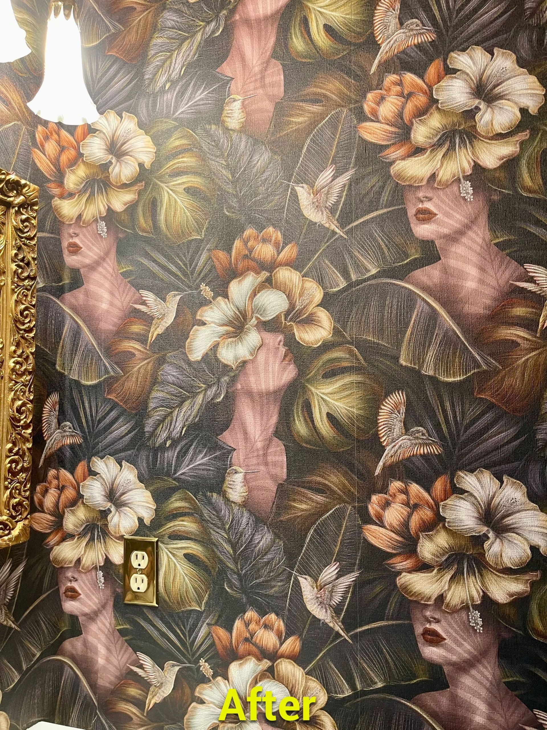 A bathroom with a painting of a woman with flowers on her head.