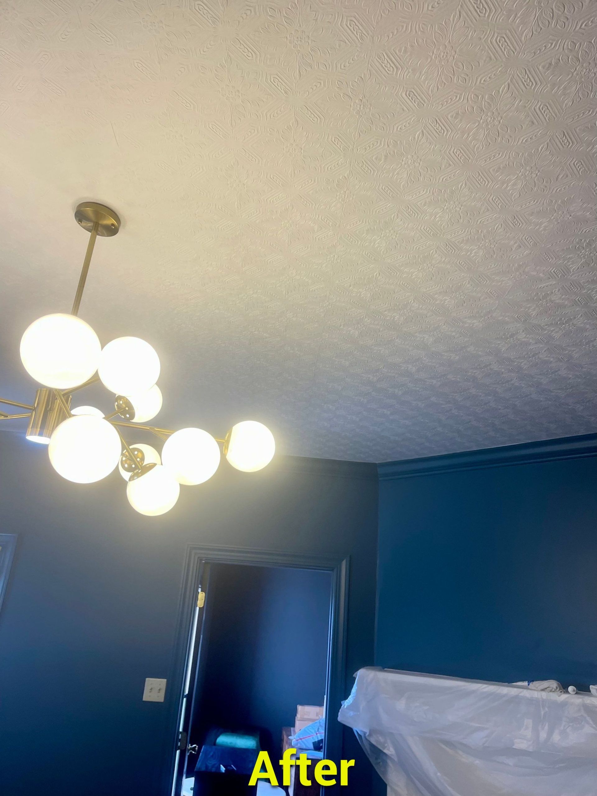A chandelier is hanging from the ceiling of a room.