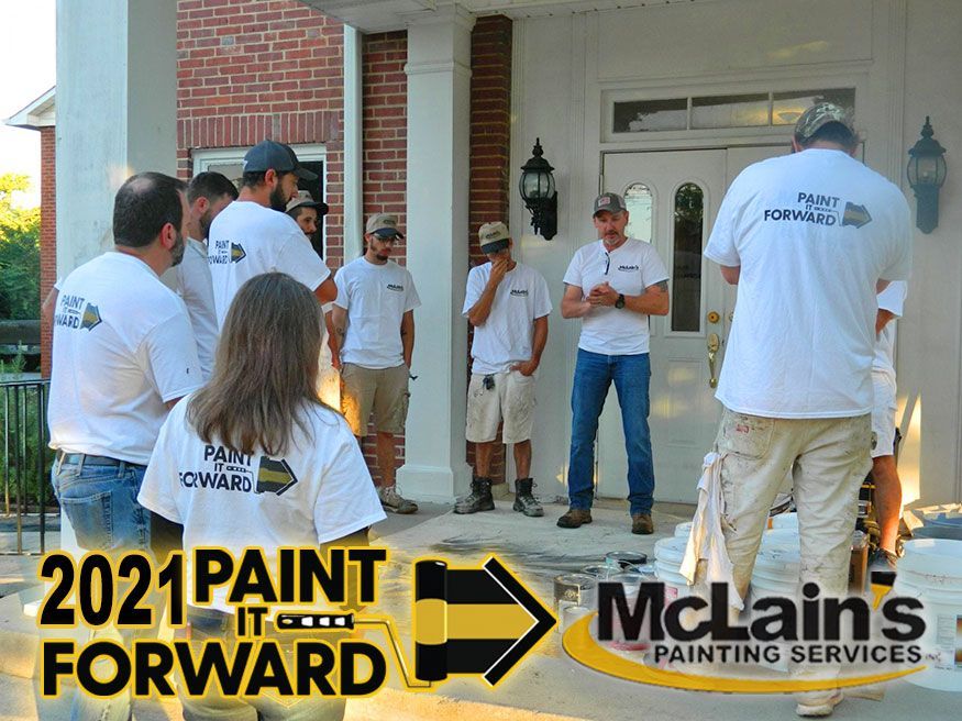 A group of people are standing in front of a house.