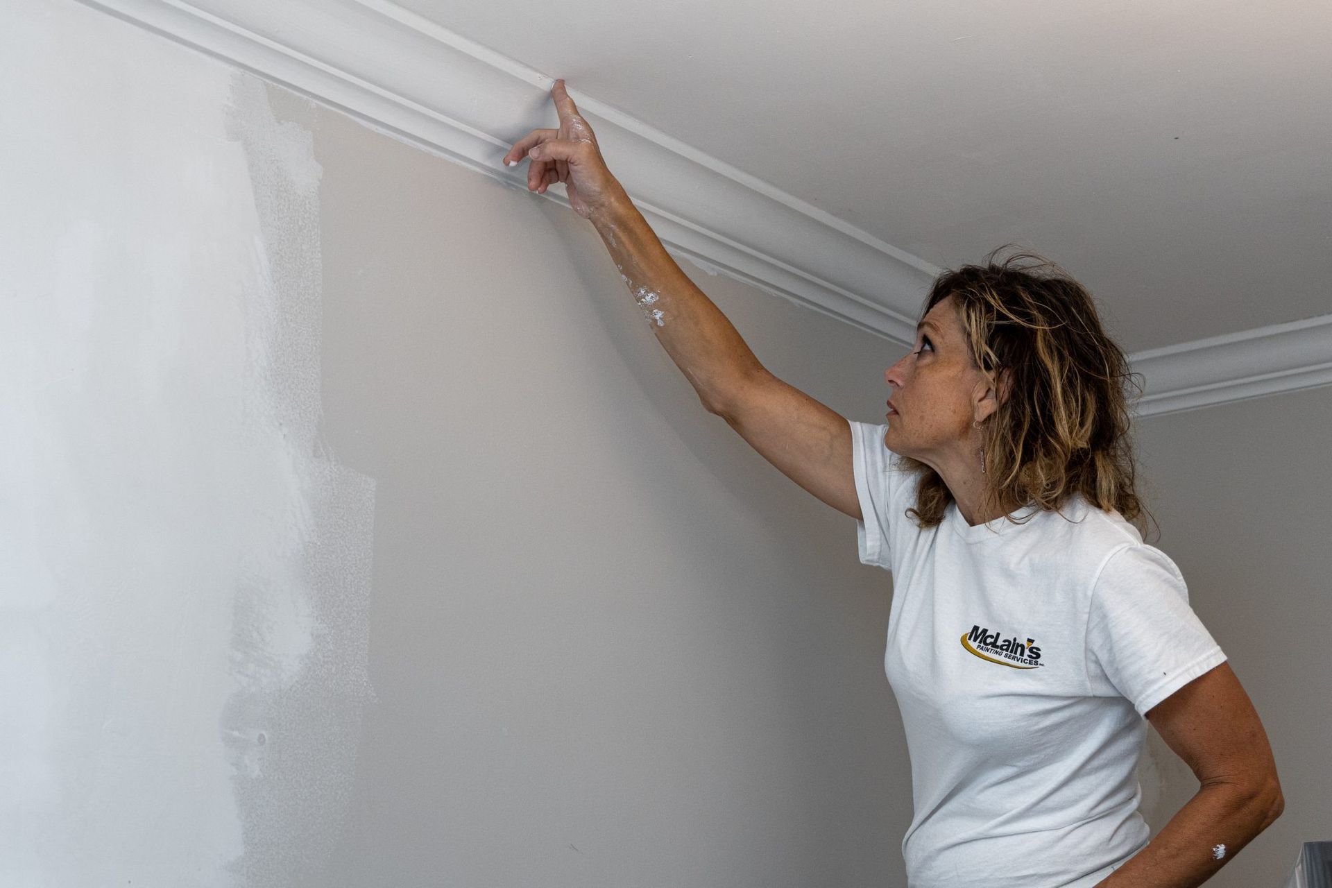 McLains employee paints ceiling trim