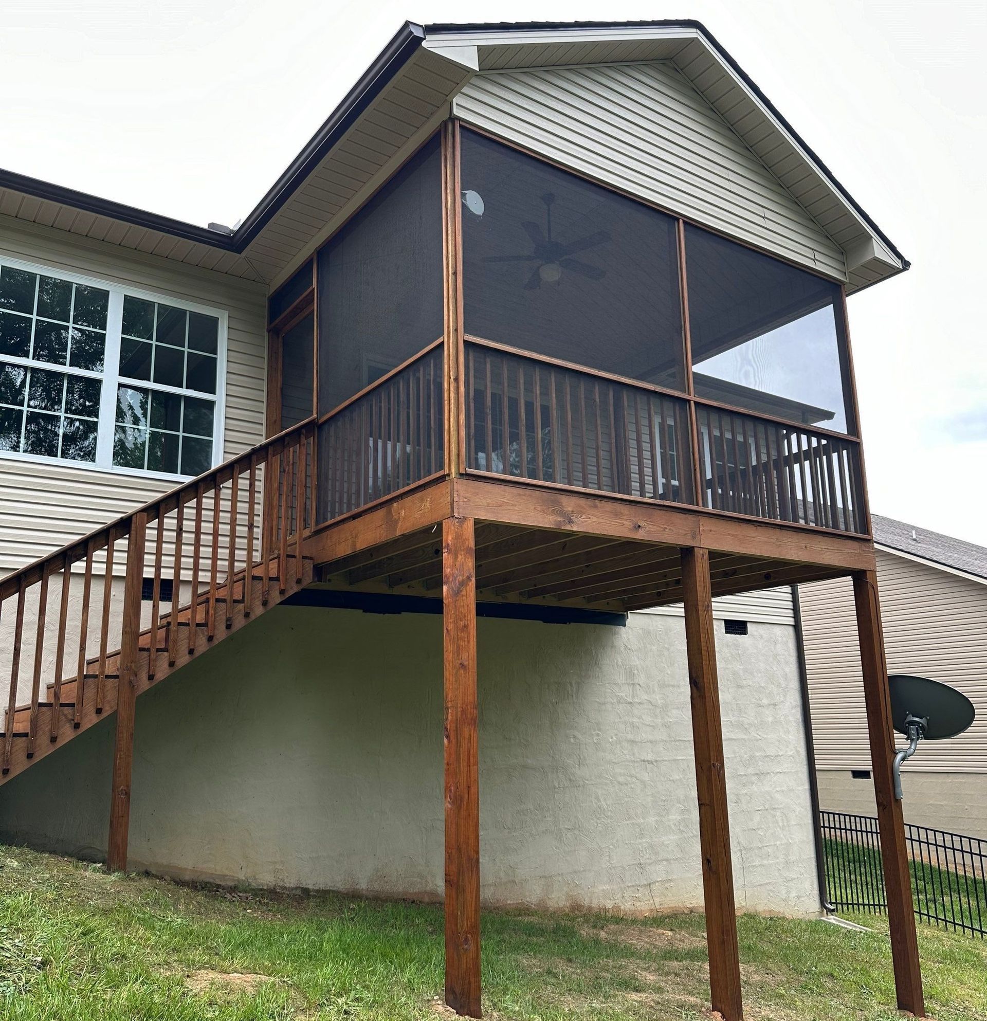 A house with a screened in porch and stairs