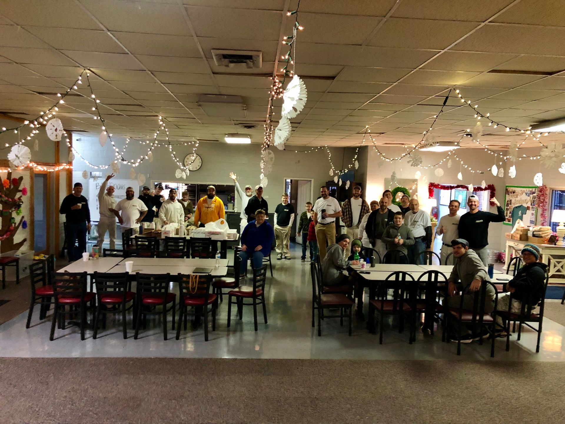 A group of people are sitting at tables in a large room.