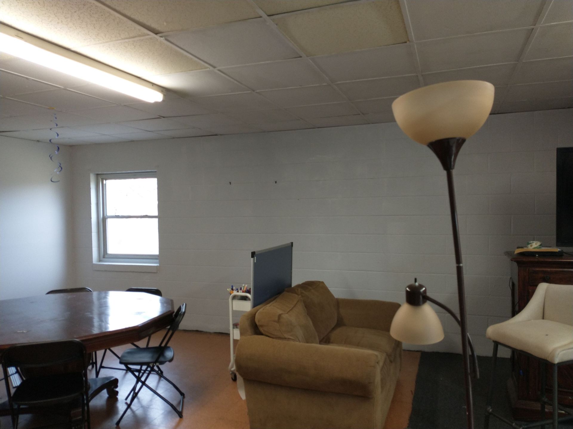 A living room with a couch a lamp and a table