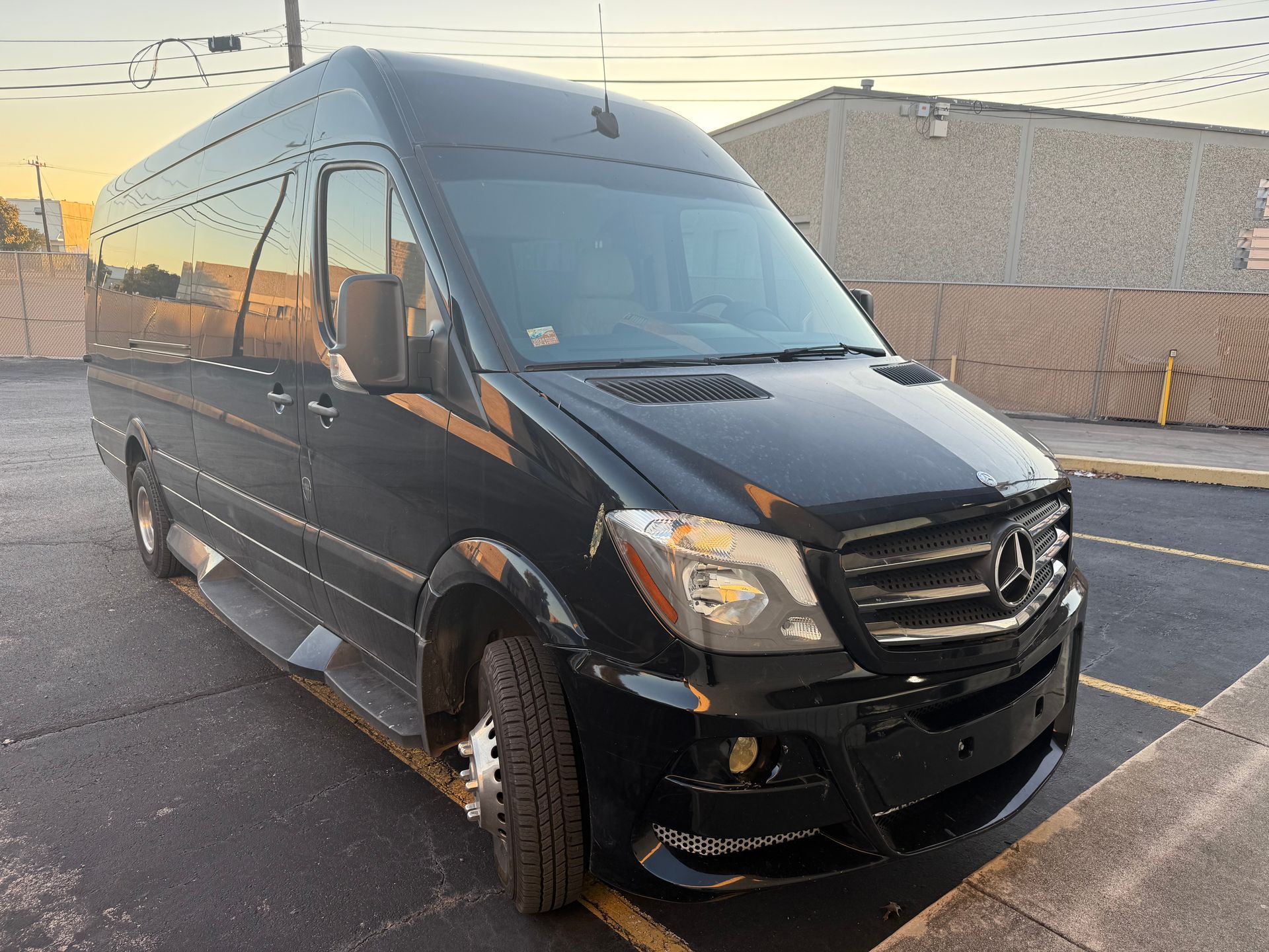 A black RV van is parked in a parking lot of RV Repair Solutions in San Antonio Texas.