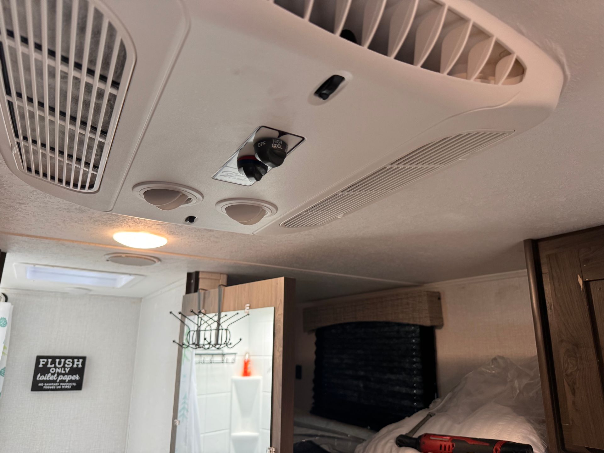 A ceiling fan is hanging from the ceiling of a rv.
