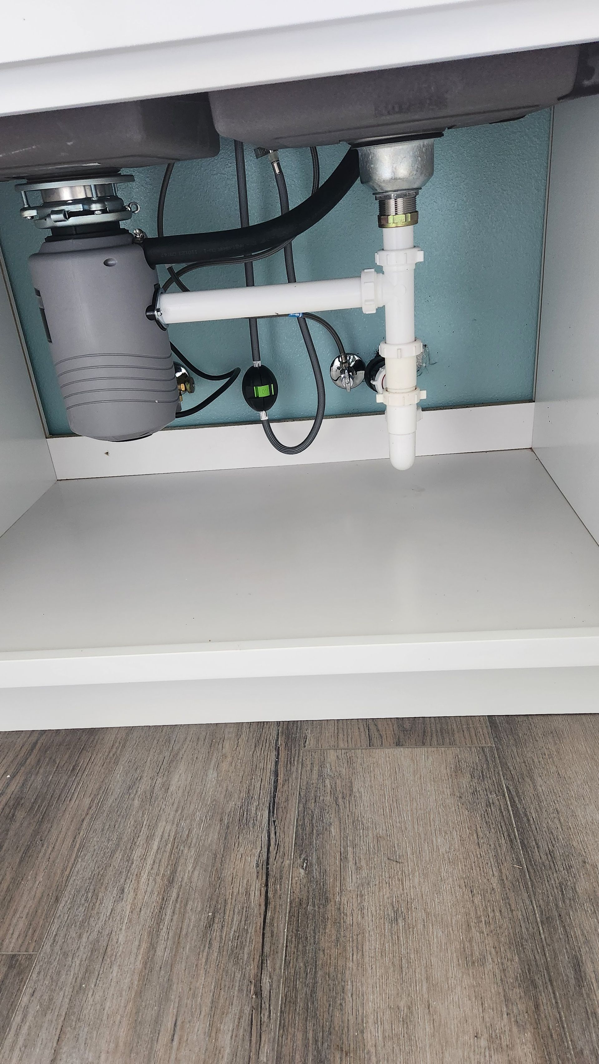 A sink with a garbage disposal underneath it.