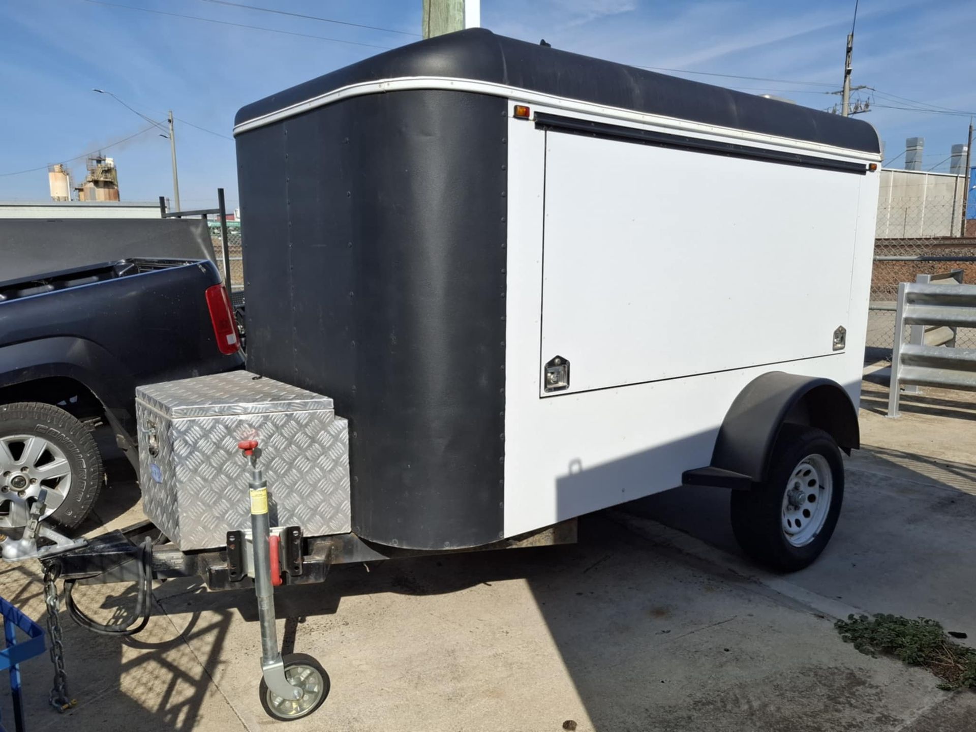 A black and white trailer is parked next to a truck – North Geelong, VIC - F Sparks & Sons