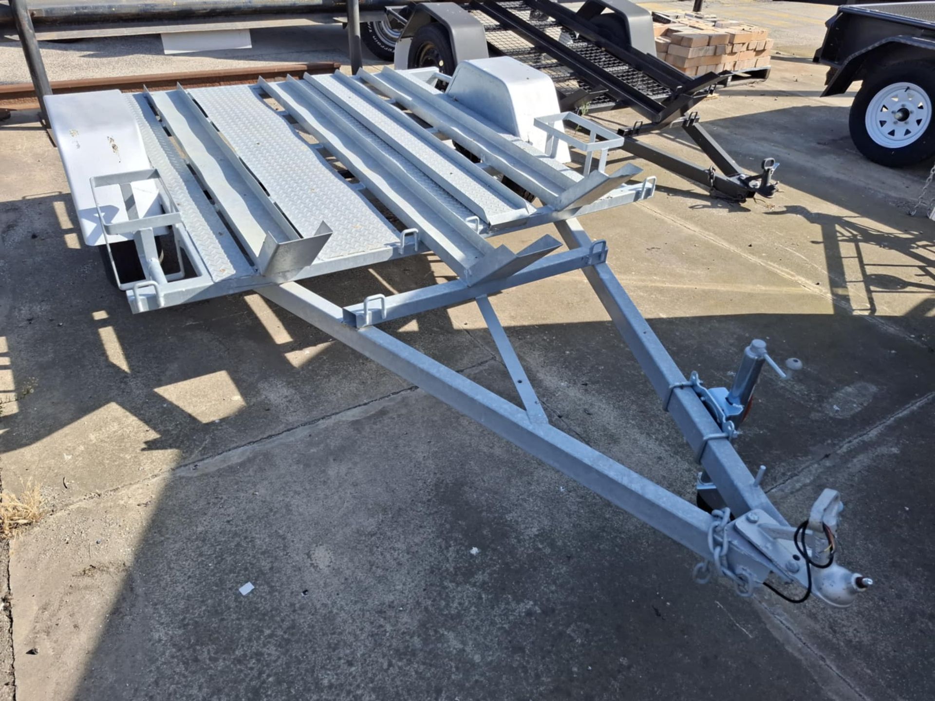 A motorcycle trailer is parked on the side of the road – North Geelong, VIC - F Sparks & Sons