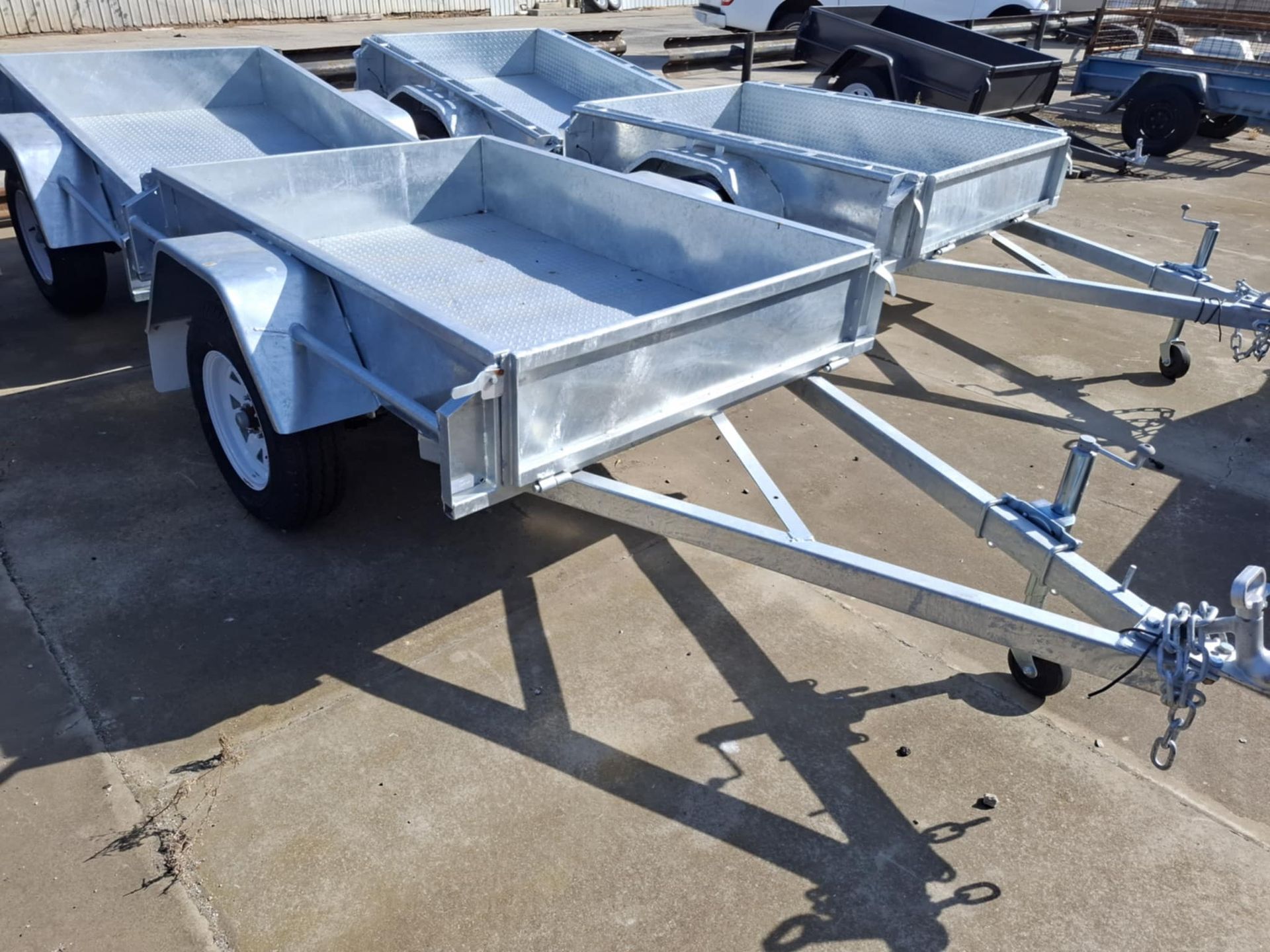 Three trailers are parked next to each other on a concrete surface – North Geelong, VIC - F Sparks & Sons