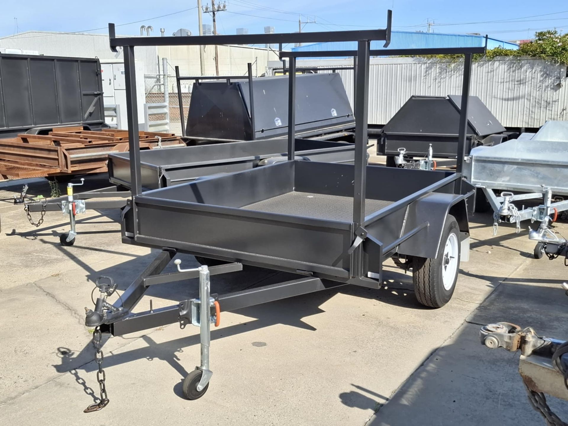 A black trailer is parked in a parking lot – North Geelong, VIC - F Sparks & Sons