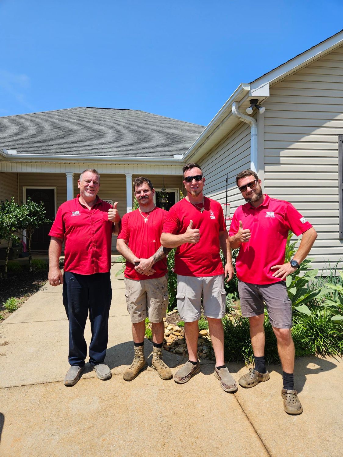 A kitchen with a large island and a stainless steel refrigerator