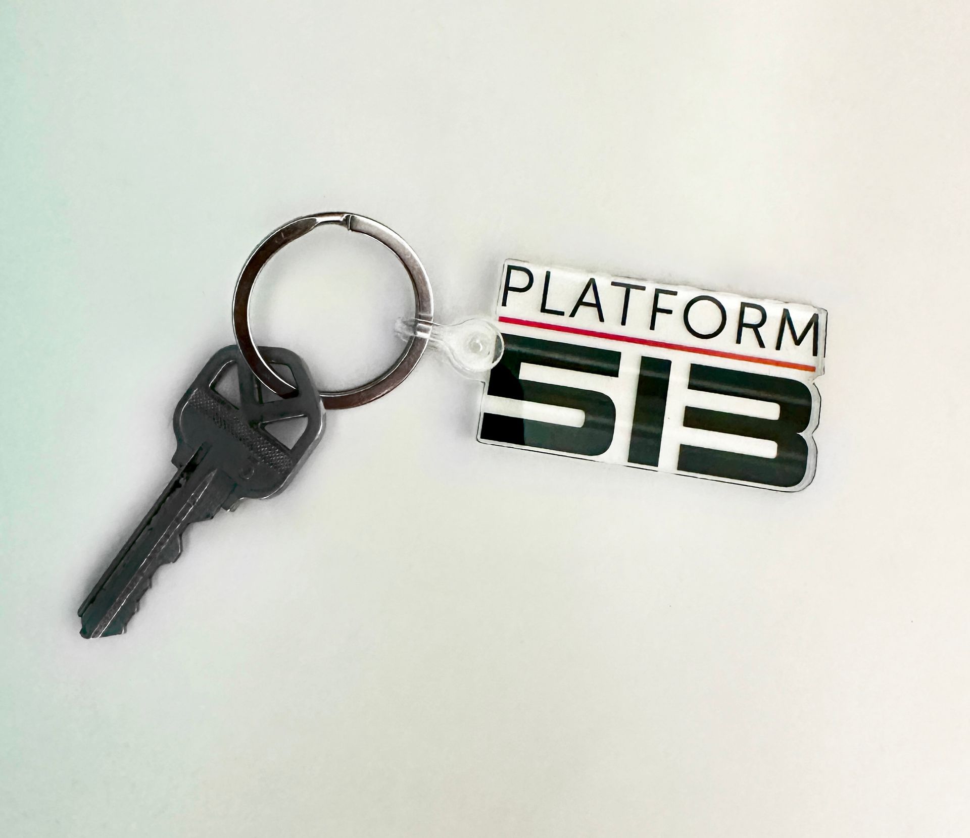A key with a platform si3 keychain attached to it