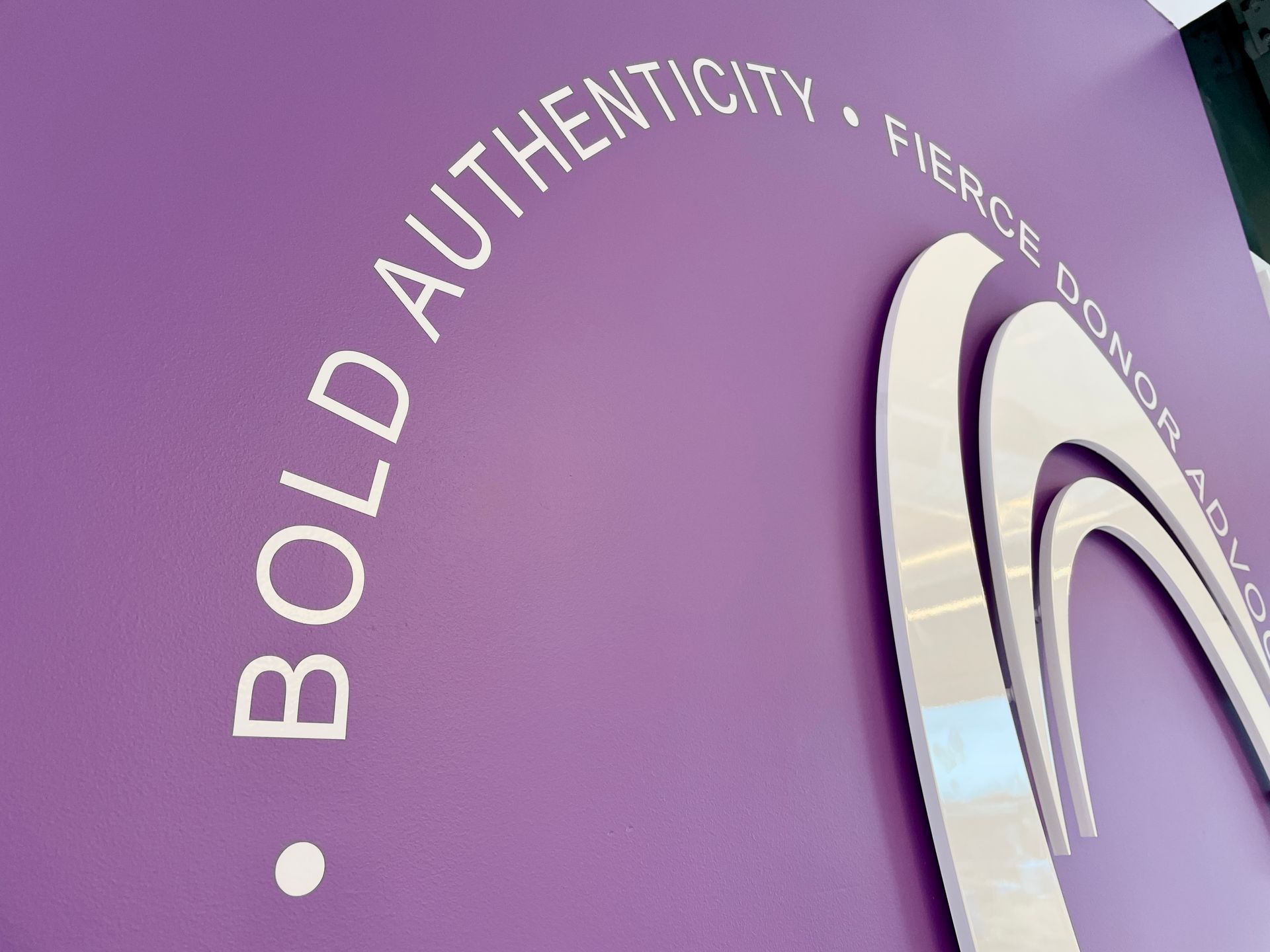 A purple wall with bold authenticity written on it