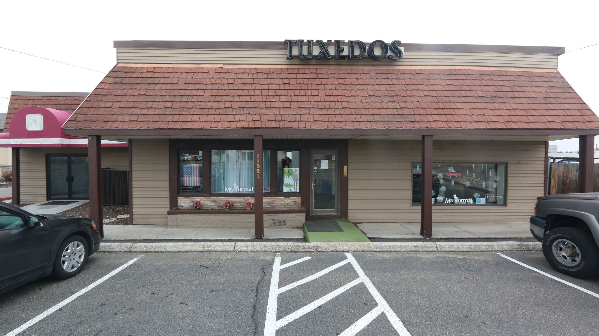 A car is parked in front of a building that says tineros