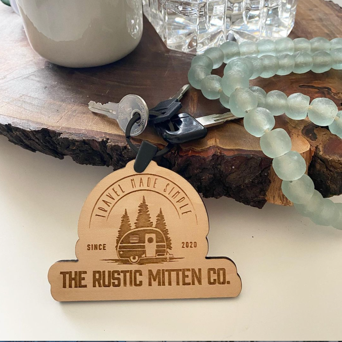 A wooden tag that says the rustic mitten co. on it