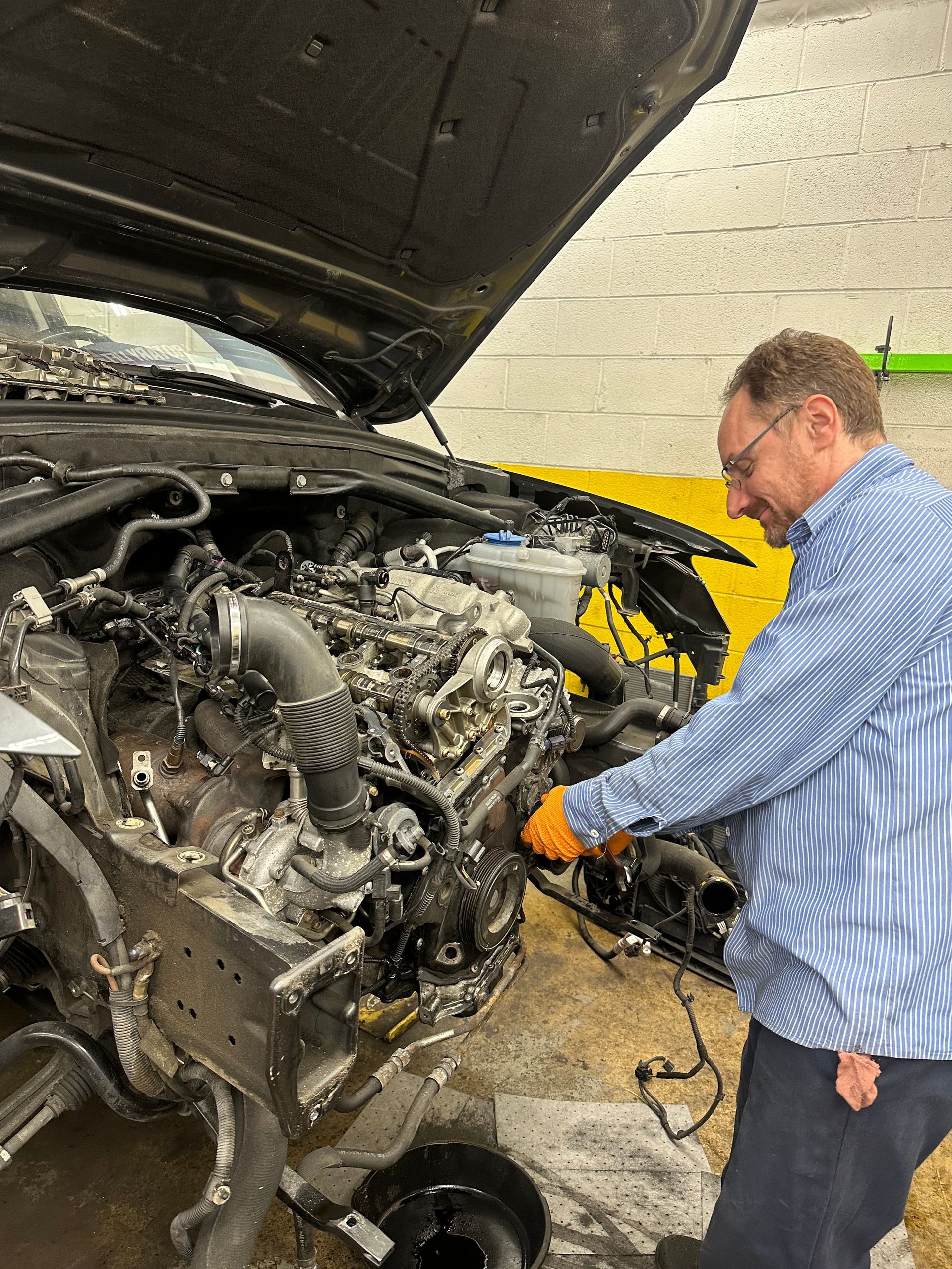 Our Mechanic Works on Vehicle Engine in Rockville, MD - Golden Gears Automotive Inc