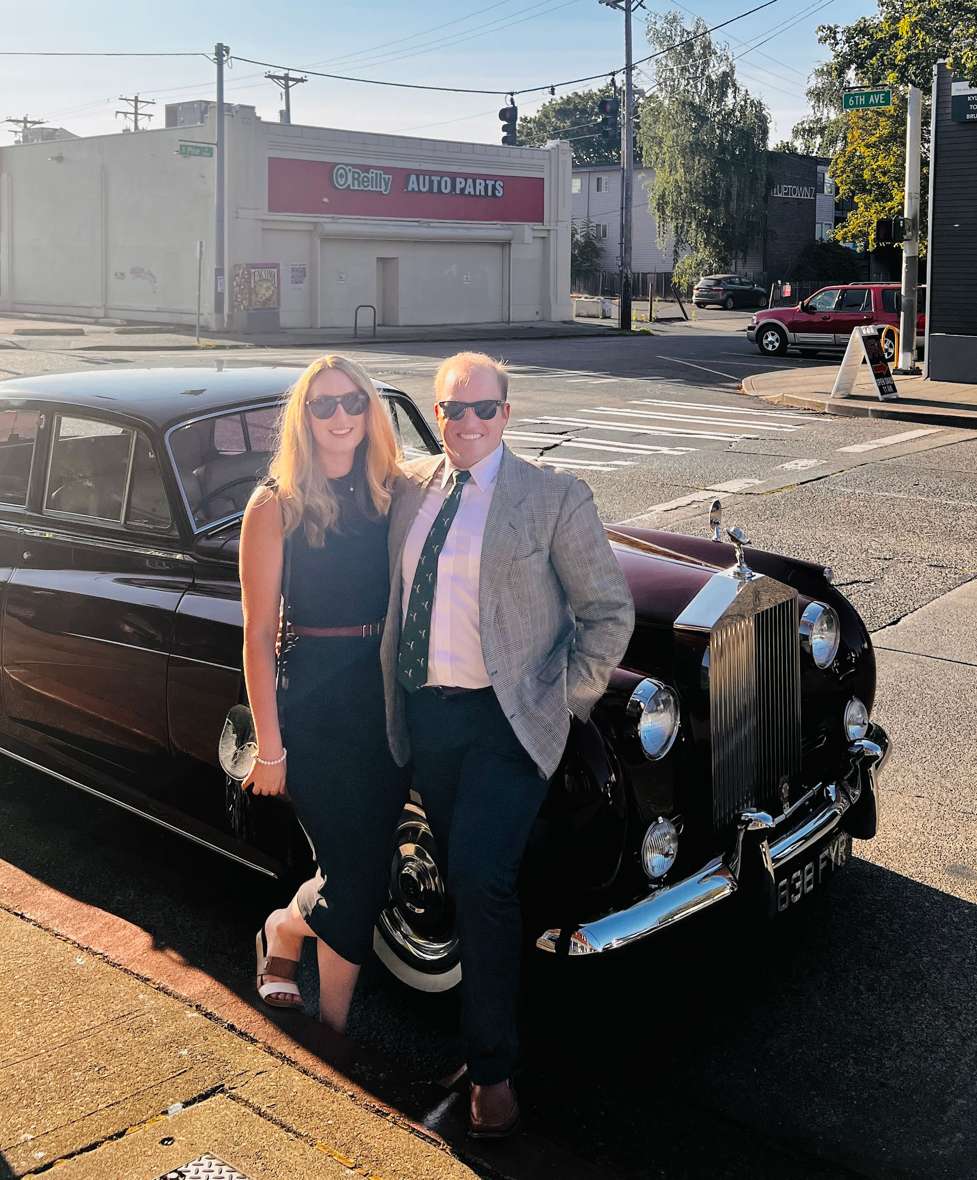 Black Dodge Challenger sports car, close-up of the front with dual headlights.