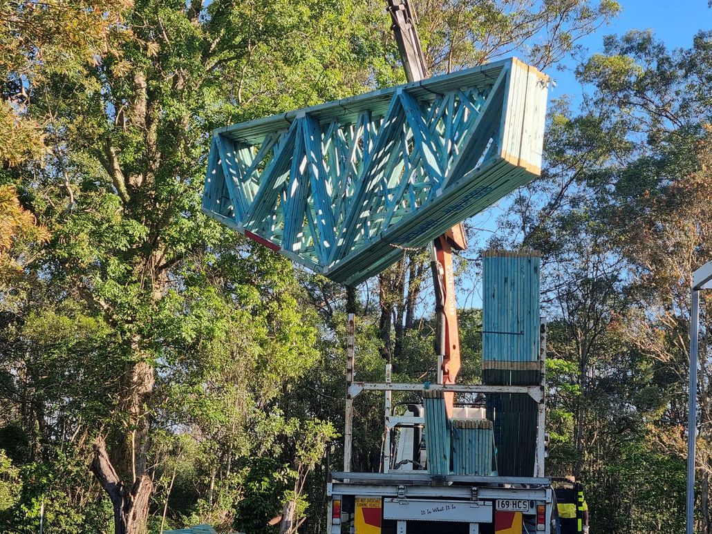 Crane lifting timber trusses