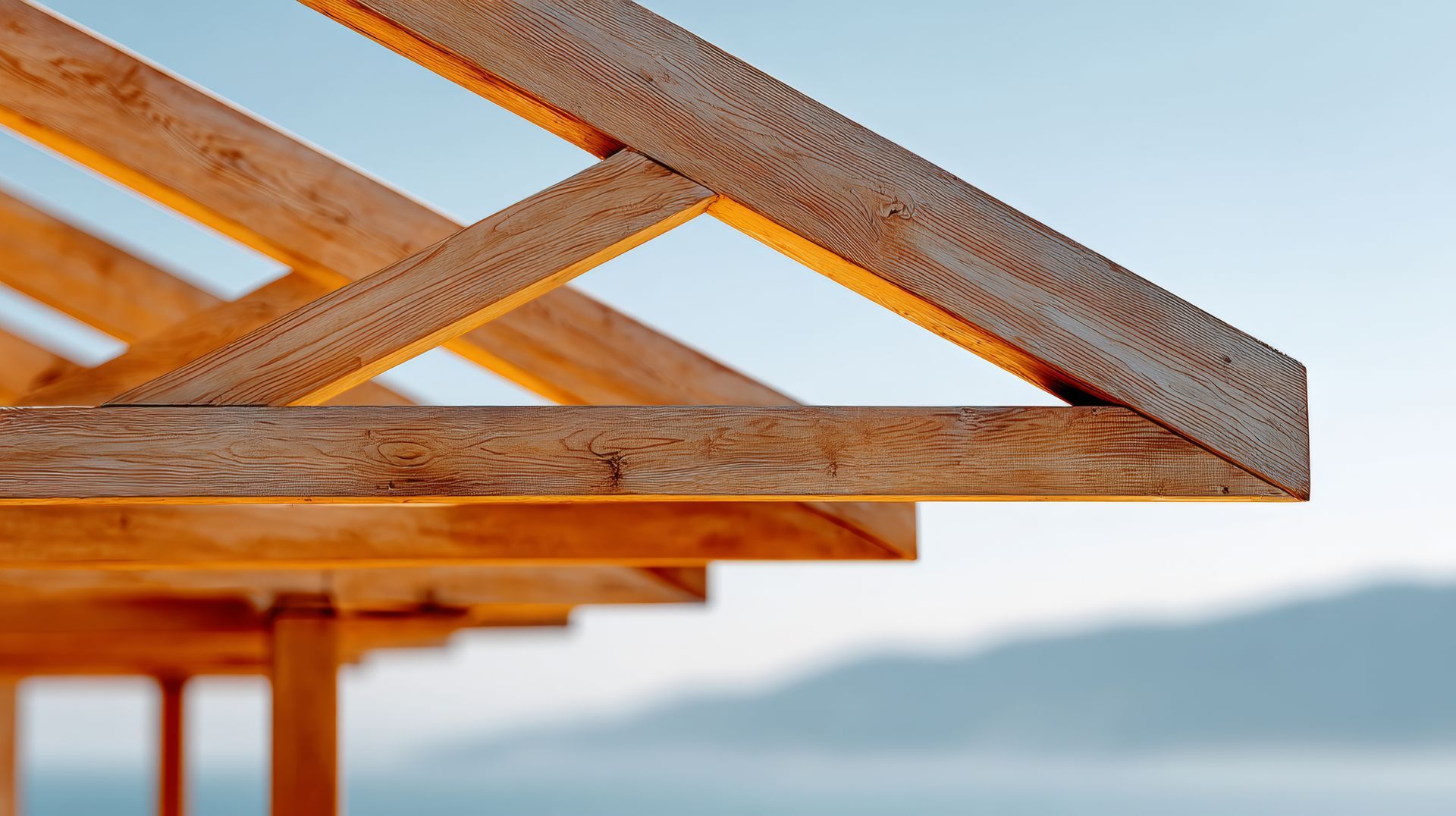 Closeup to the corner of timber roof trusses with blurred background. Closeup to the corner of timber roof trusses with blurred background.