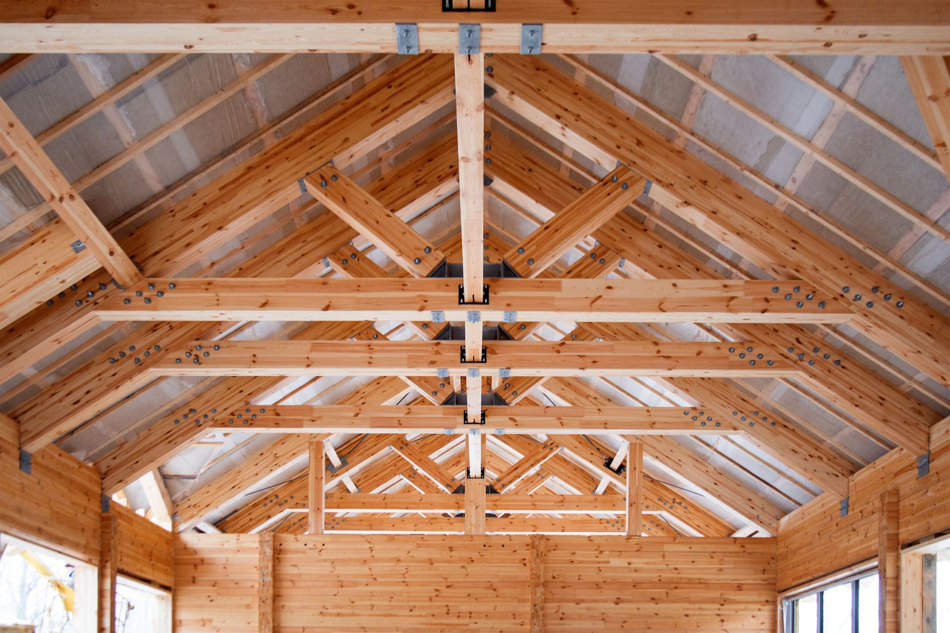 Interior view of a wooden truss structure. Interior view of a wooden truss structure.