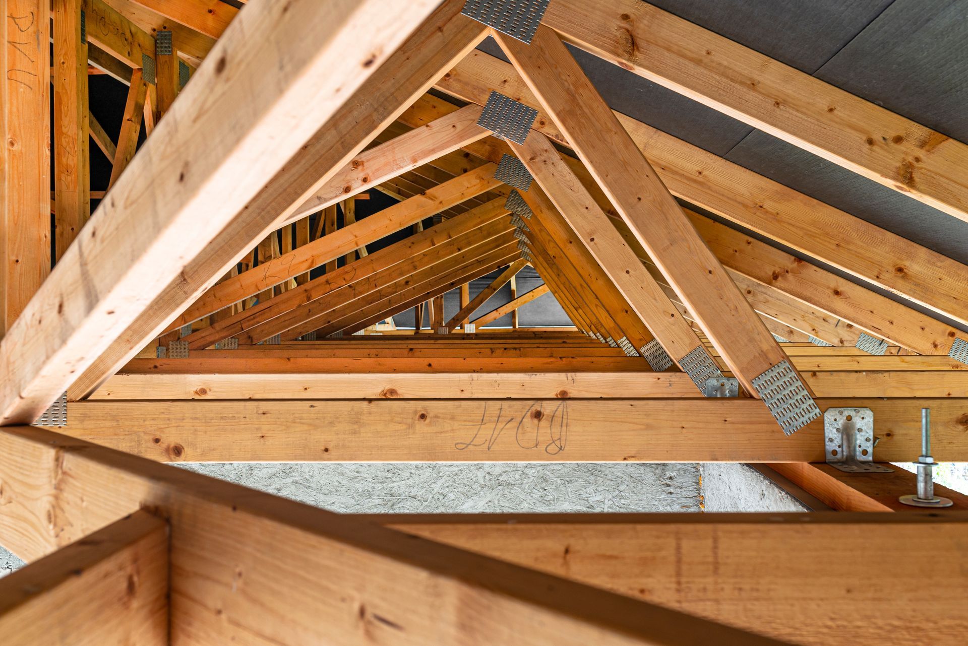 Roof trusses covered with a membrane on a detached house under construction, viewed from the inside. Roof trusses covered with a membrane on a detached house under construction, viewed from the inside.