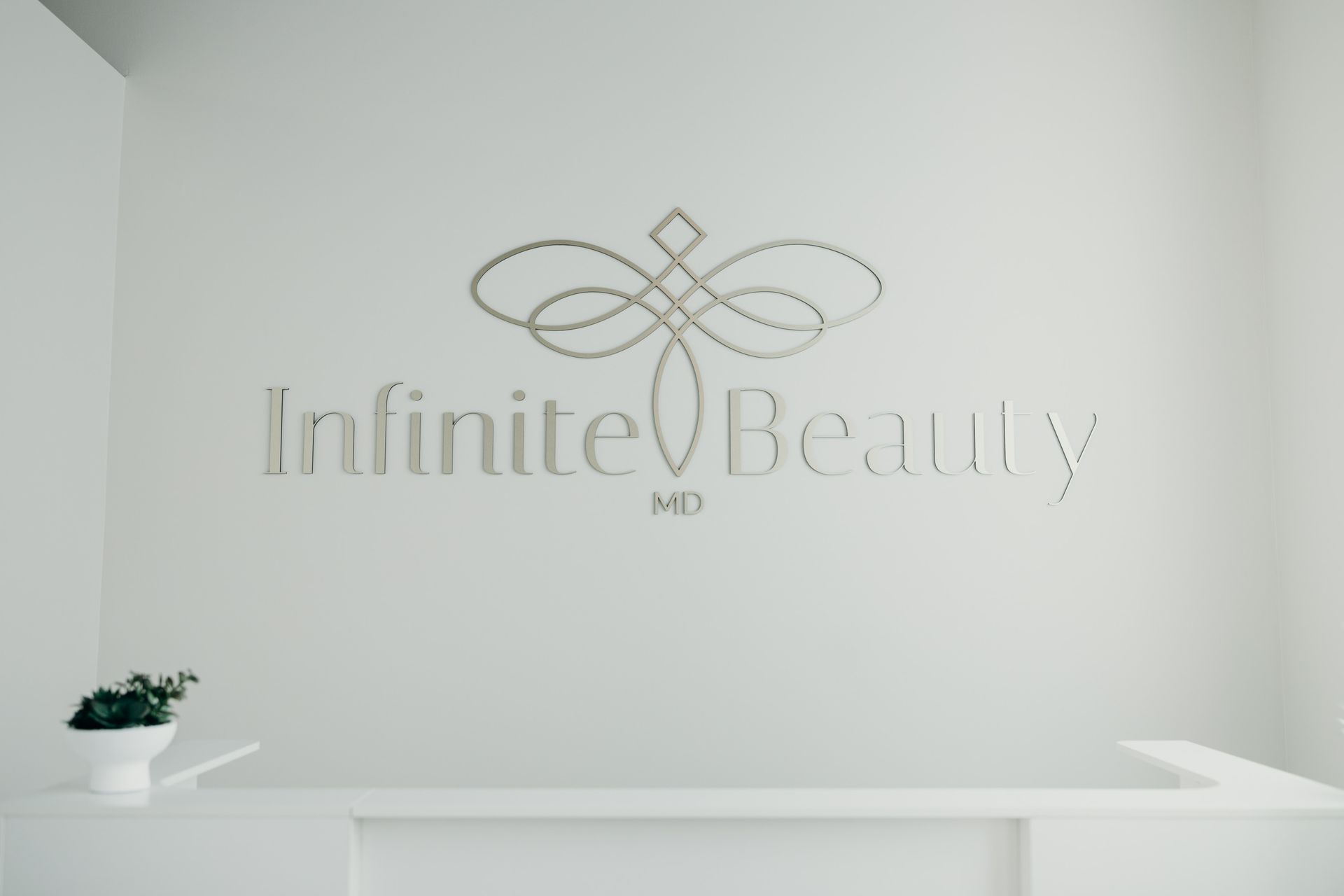 A white wall with infinite beauty md written on it