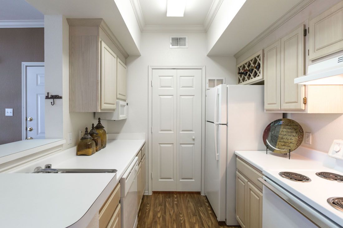 View of a modern kitchen with white cabinets and appliances