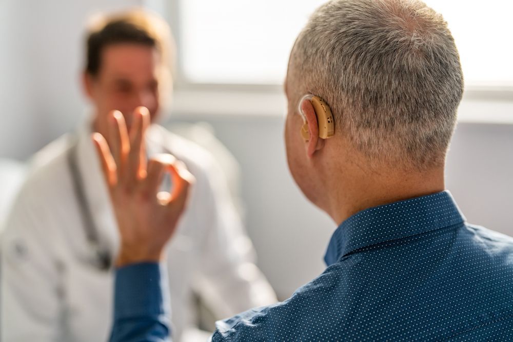 Doctor and Male Patient With Hearing Aid — Moama, NSW — Bathurst, NSW — Murray Hearing Services
