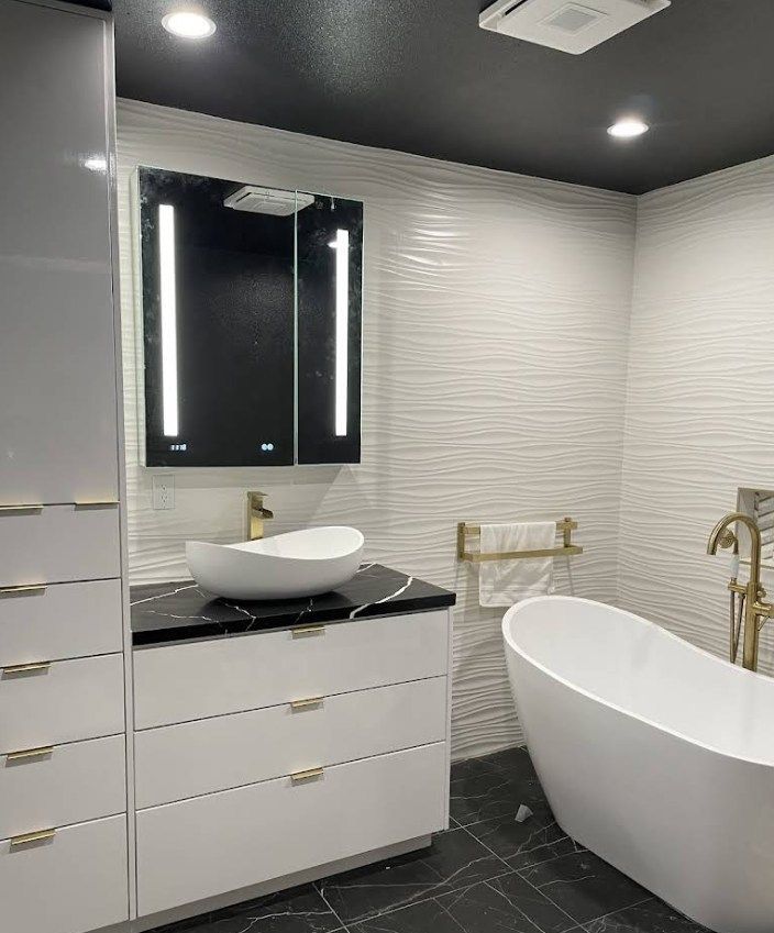 Modern bathroom with dark ceiling and illuminated mirror.