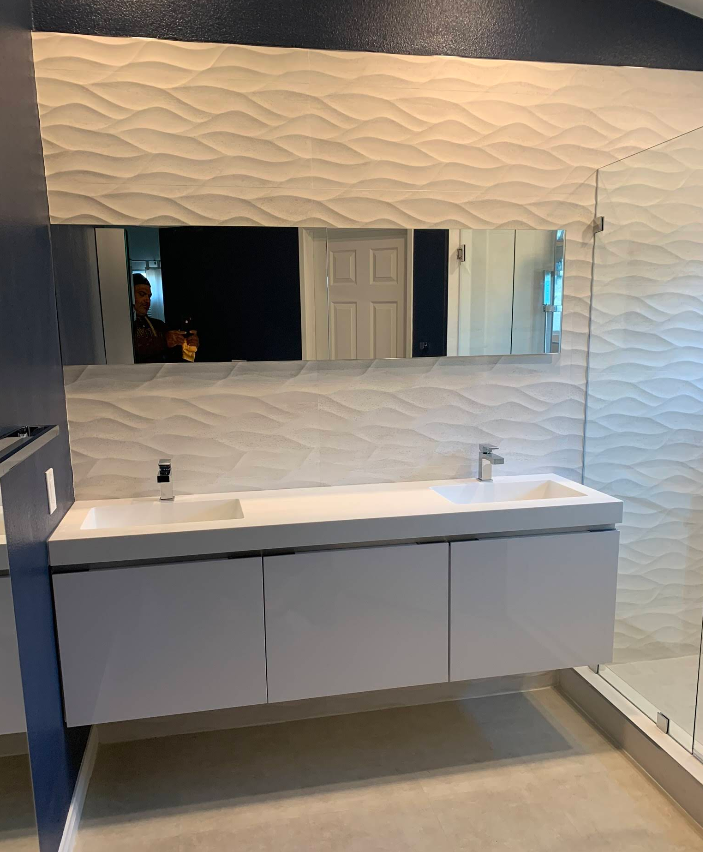 Contemporary home entrance with stone wall facade and wooden door.