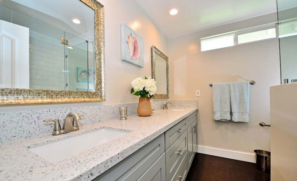 Double sink bathroom vanity with large mirror and granite countertop.