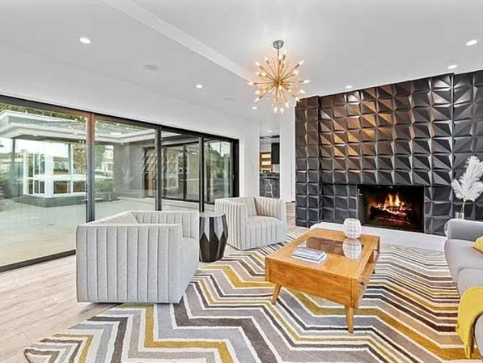 Modern living room with fireplace and sliding glass doors.